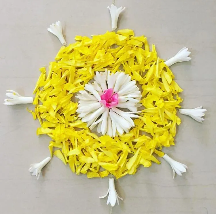 Simple yellow and white pookolam with pink flower center