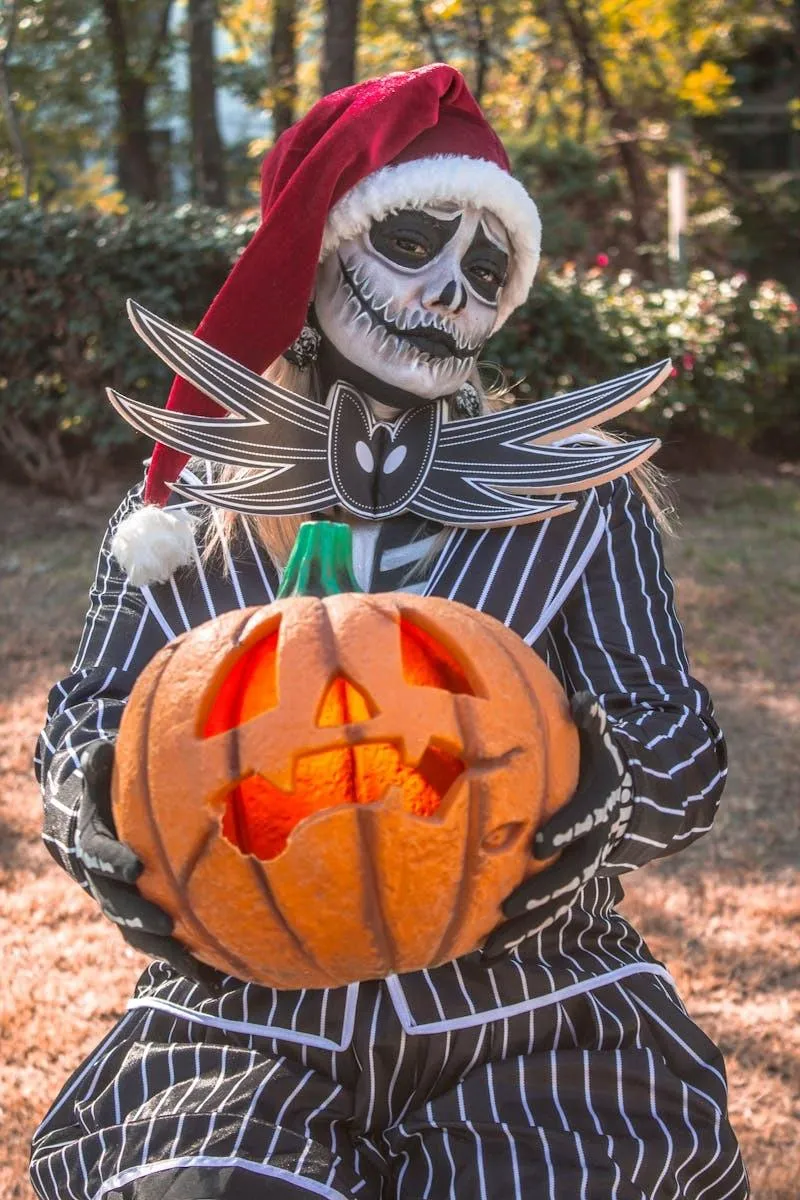 Skeleton Costume Man with Painted Pumpkin Lantern image