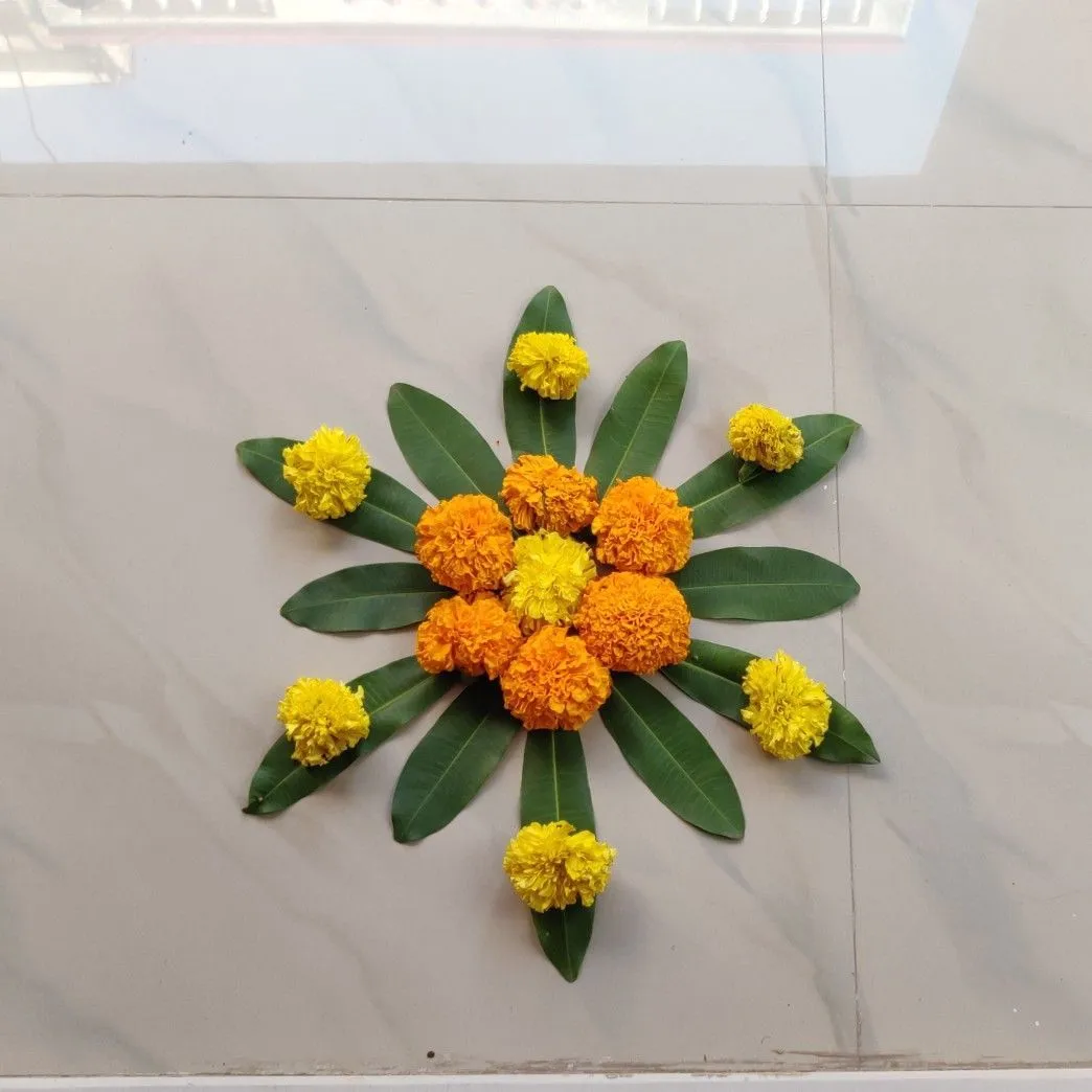 Small Athapookolam design with leaves and Marigolds image