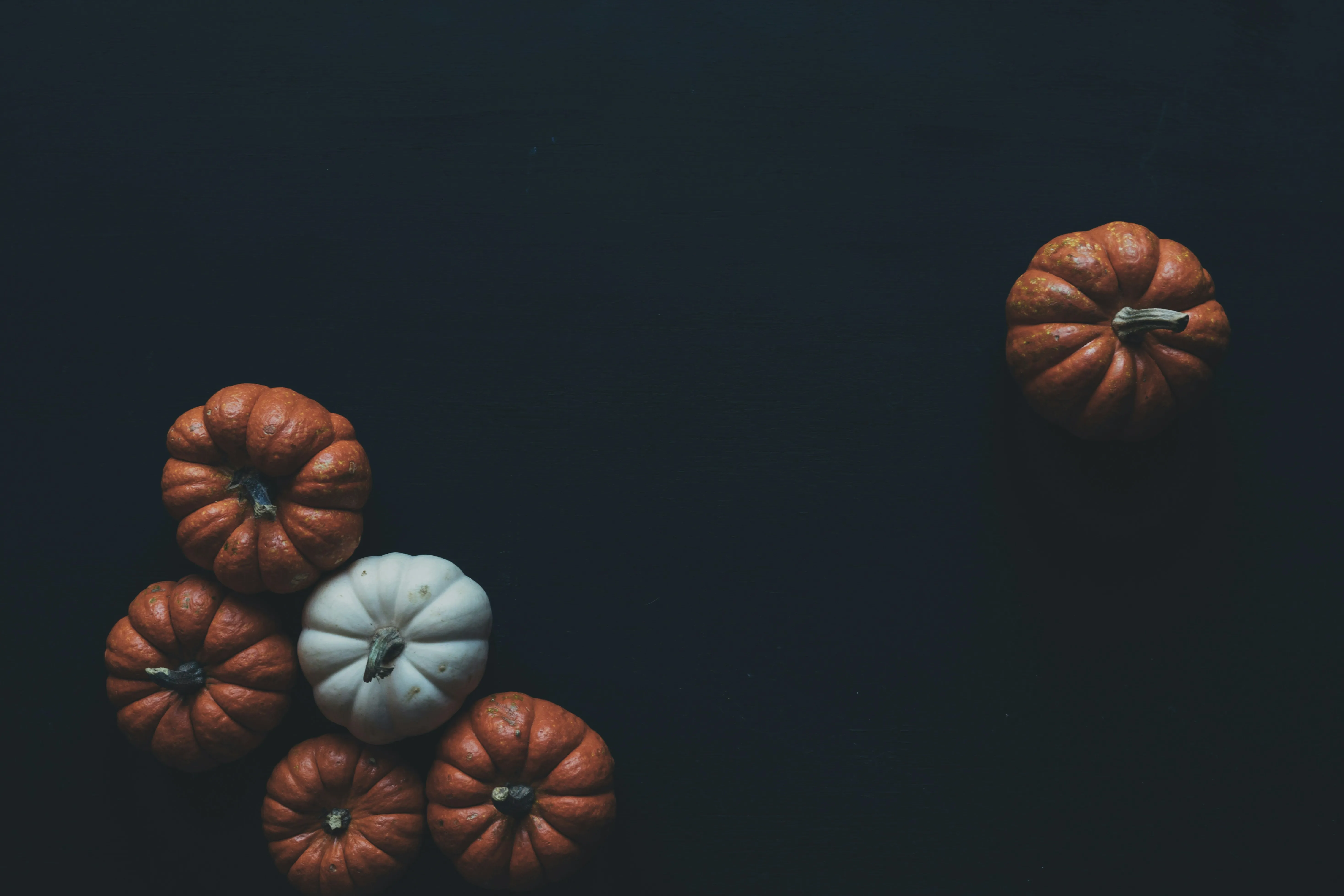 Small Halloween Pumpkins Floating on Dark Background Image