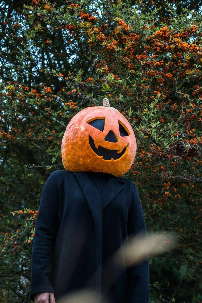 Smiling Pumpkin Head Standing by Autumn Tree Wallpaper