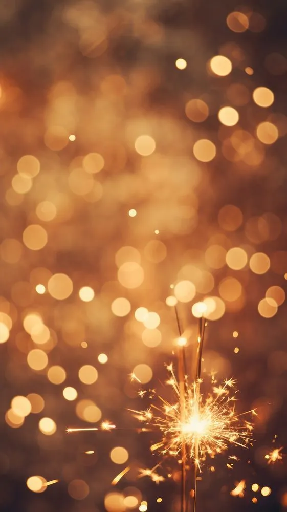 Soft Glow of Fireworks Sparkling Against Dark Background
