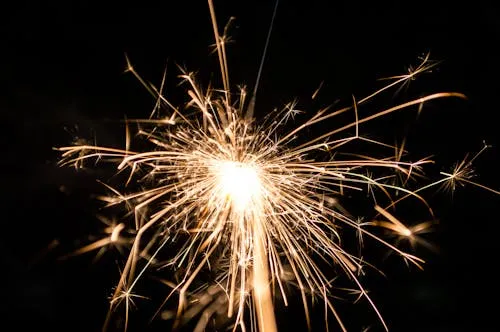 Sparkler Glowing Brightly Against Dark Background HD