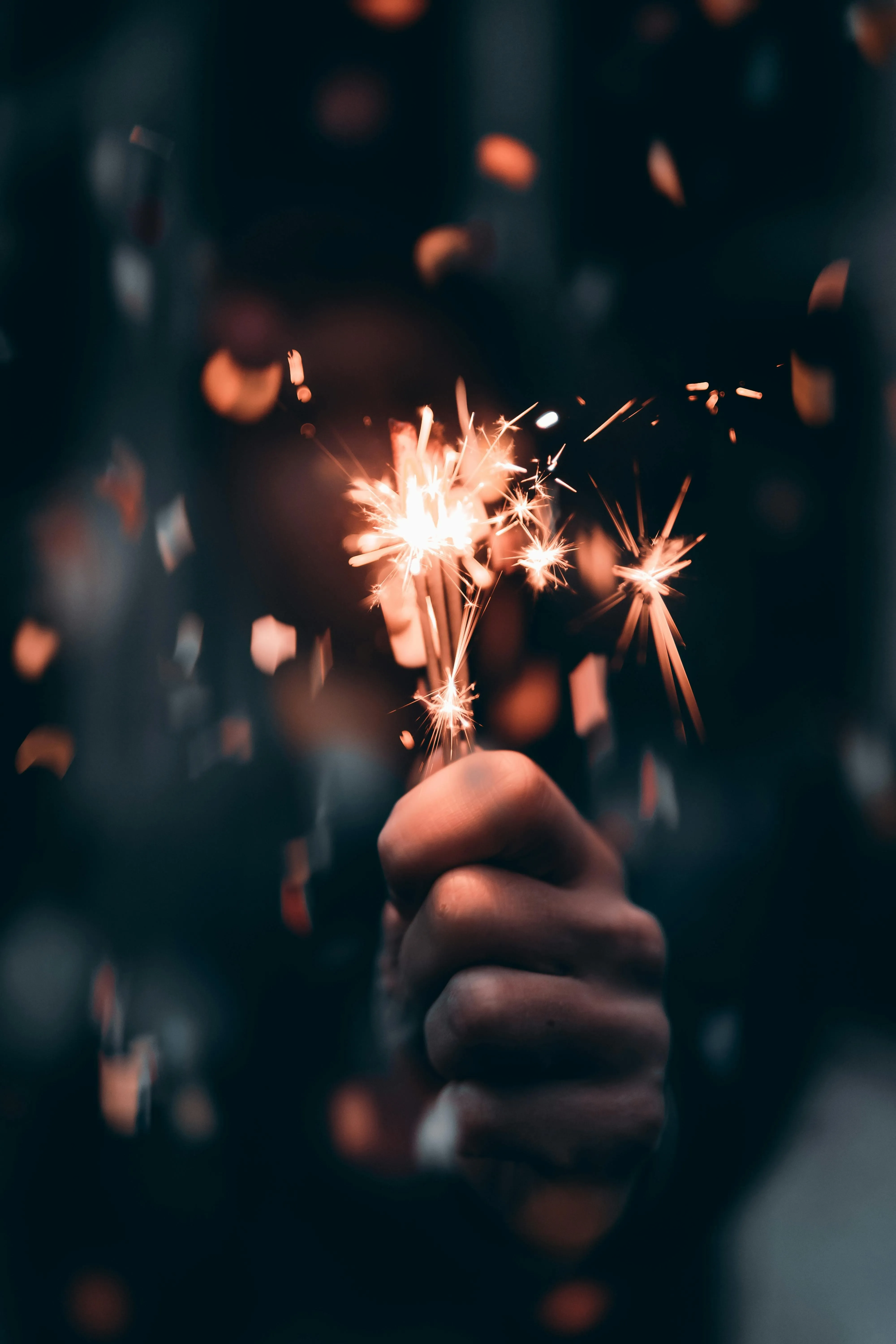 Sparkler glowing brightly in a dark background Wallpaper