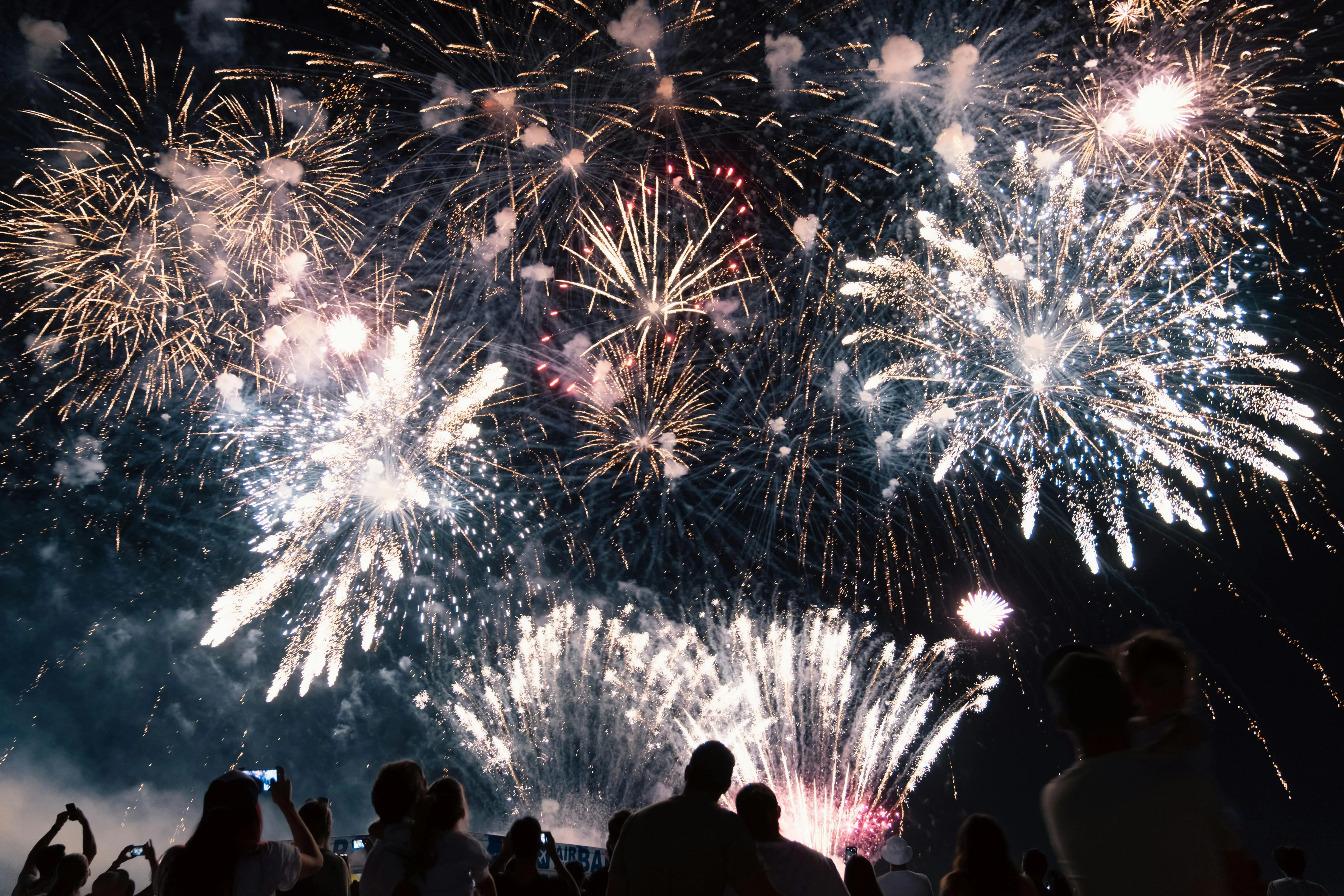 Spectacular Fireworks Show over a Crowd at Night