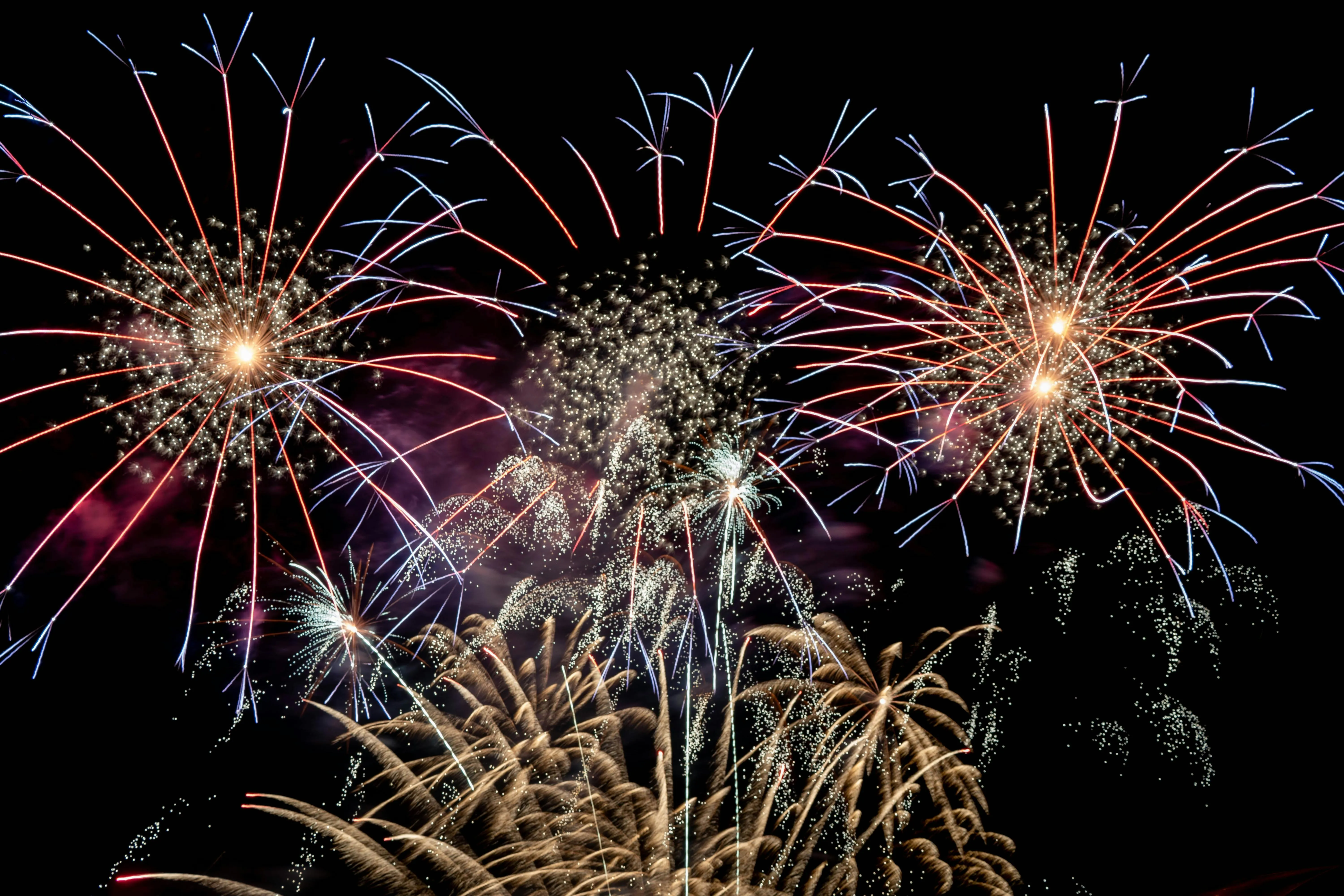 Spectacular Fireworks Show over City at Night Wallpaper