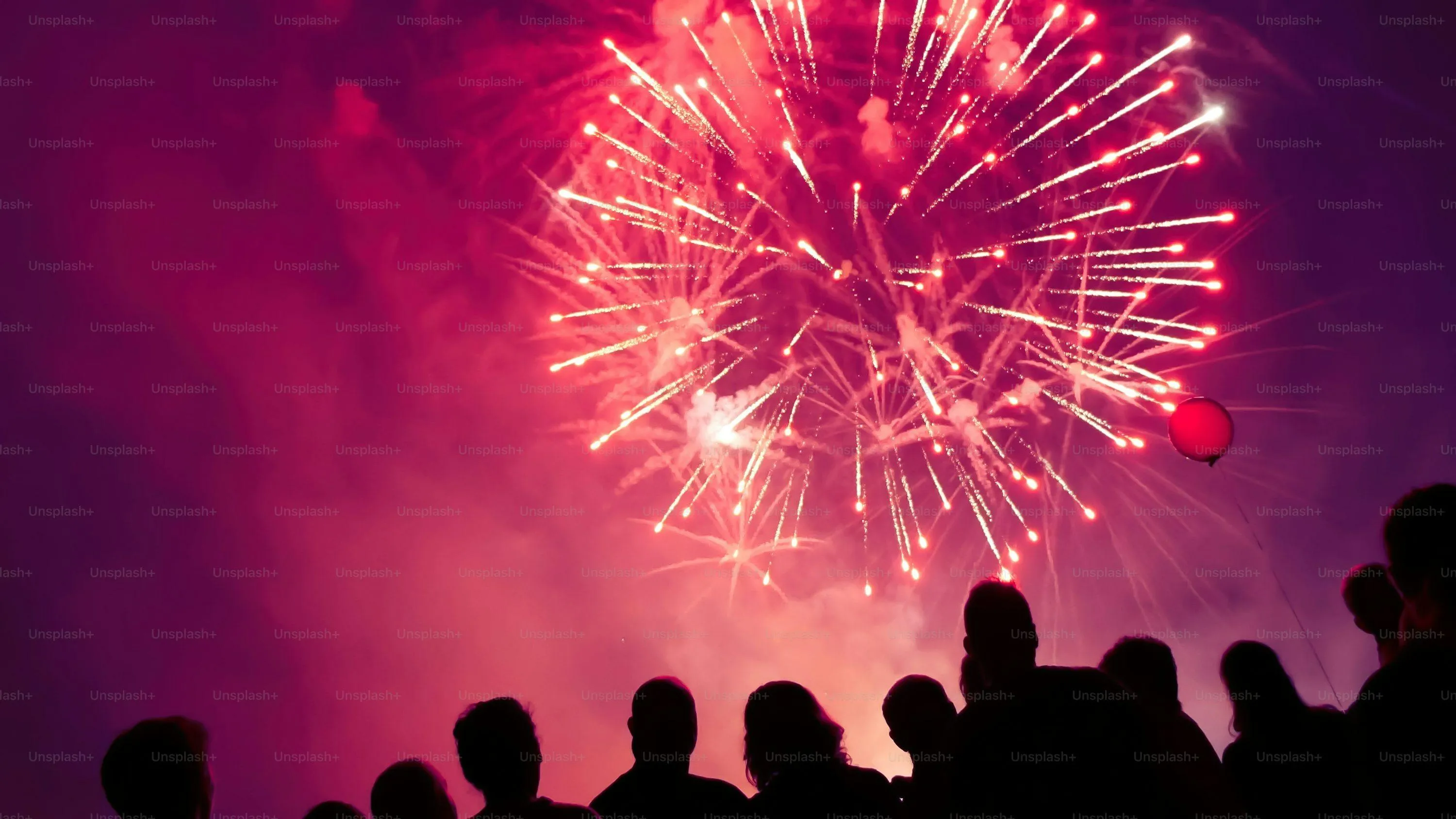 Spectacular Fireworks with Silhouettes in Front Wallpaper