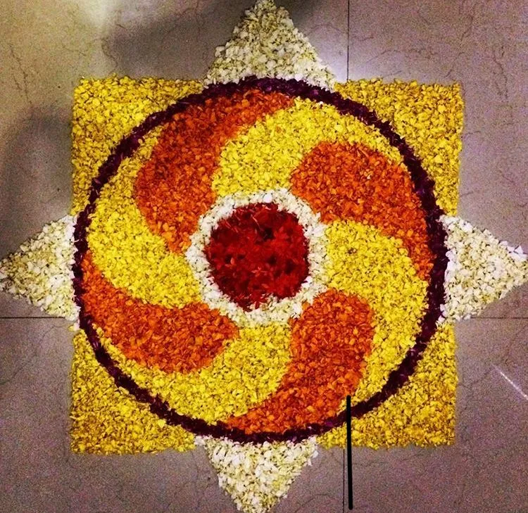 Spinning Athapookolam Design with Yellow and Orange Petals