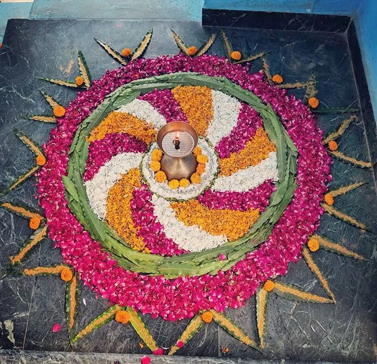 Spiral Flower Rangoli with lamp and fresh petals HD image