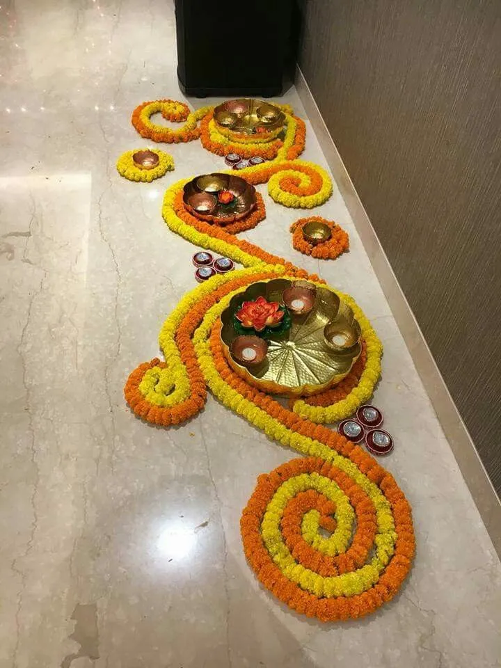 Spiral pookolam with Diyas and Brass decor Plates image