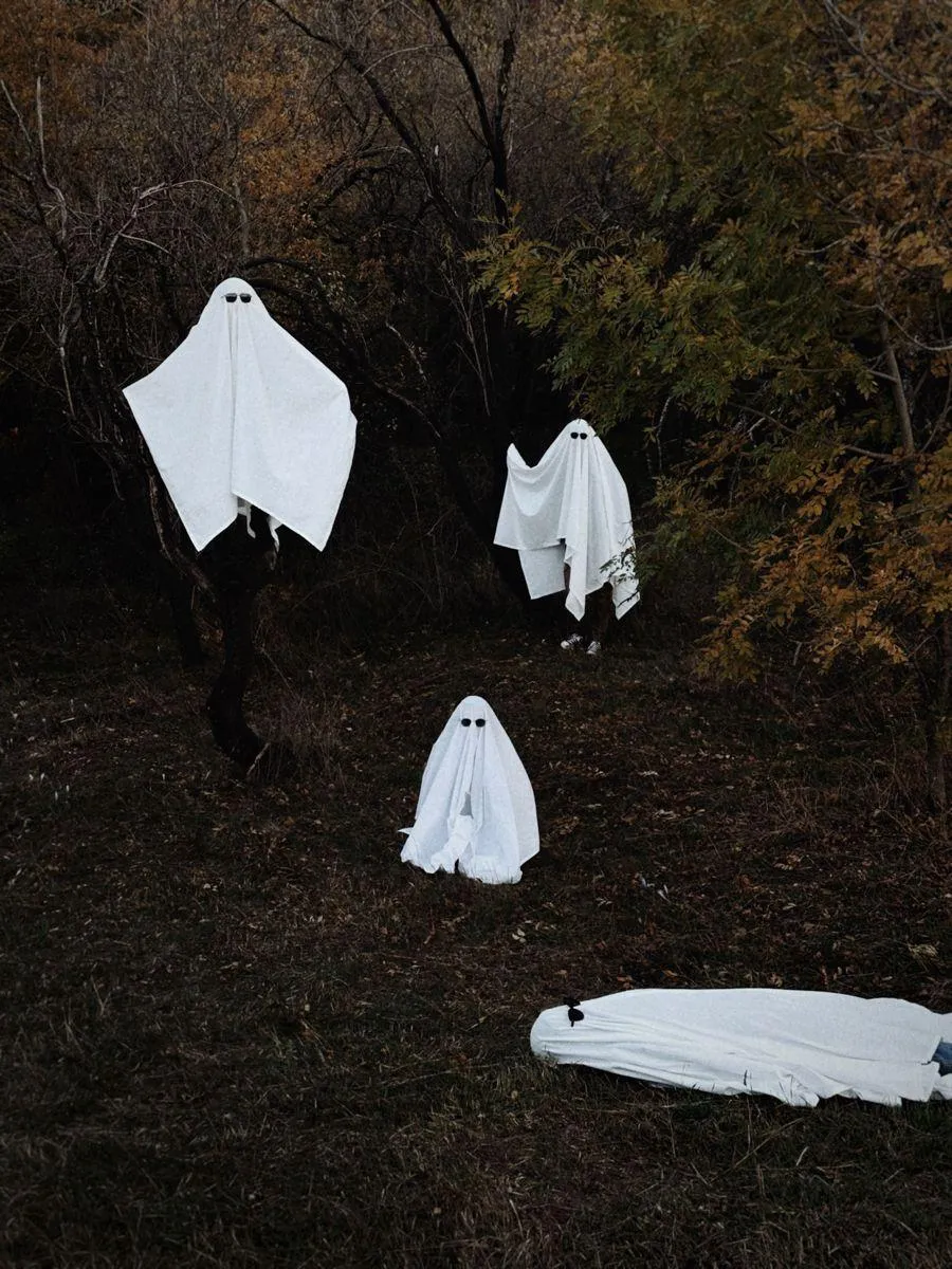 Spooky Halloween Decoration with Hanging Ghosts Wallpaper