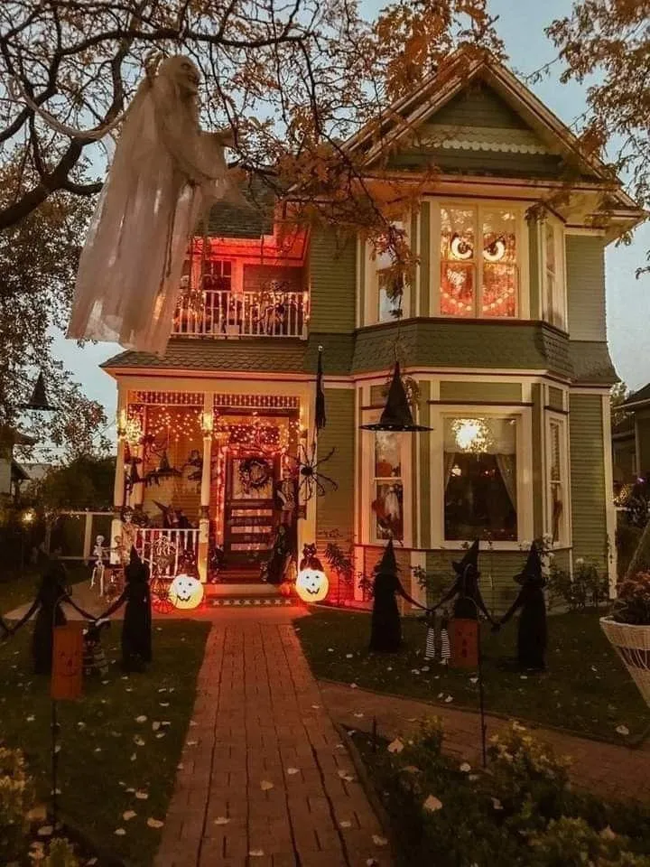 Spooky Halloween House Decorated with Lights and Pumpkins
