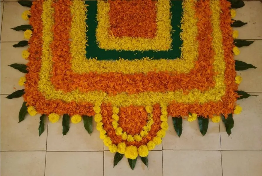 Square Onam pookalam with yellow and orange marigolds image