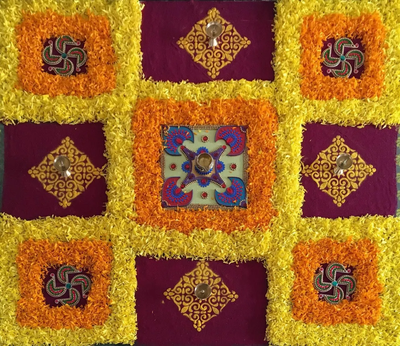 Square Pookalam design with Diyas and detailed Patterns
