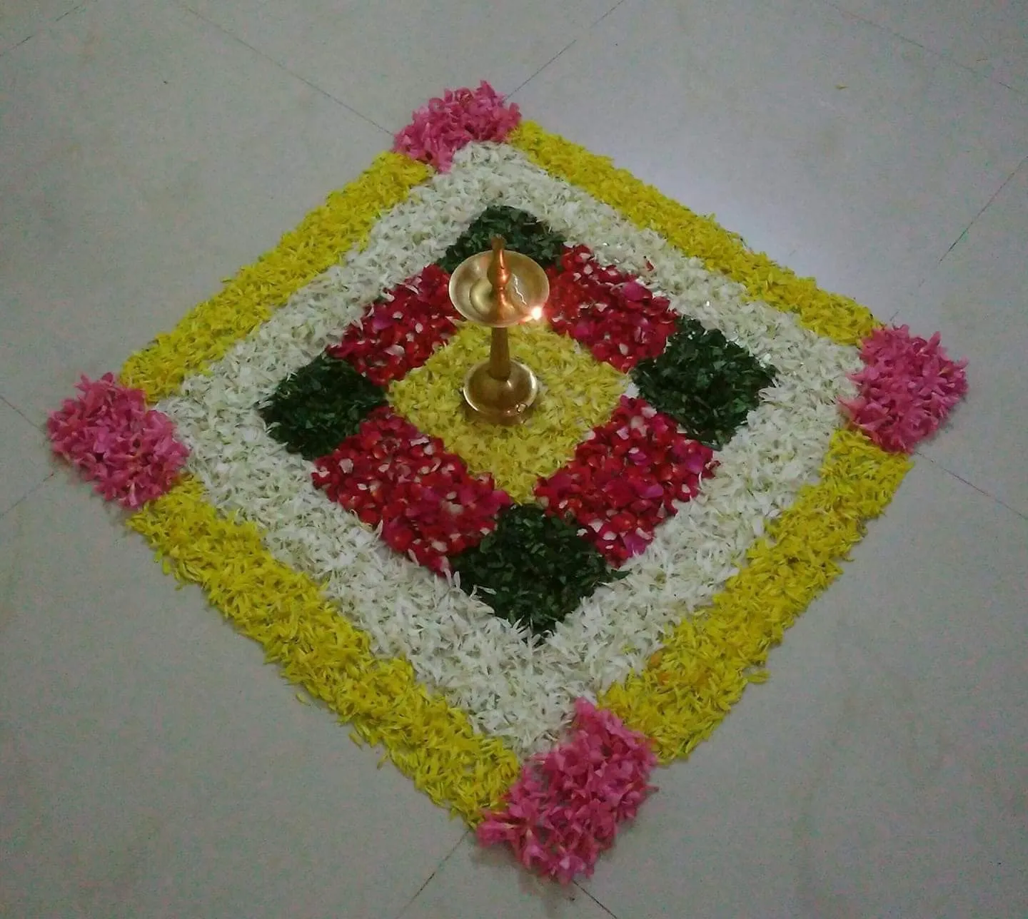 Square shape pookolam with alternative colour petals image