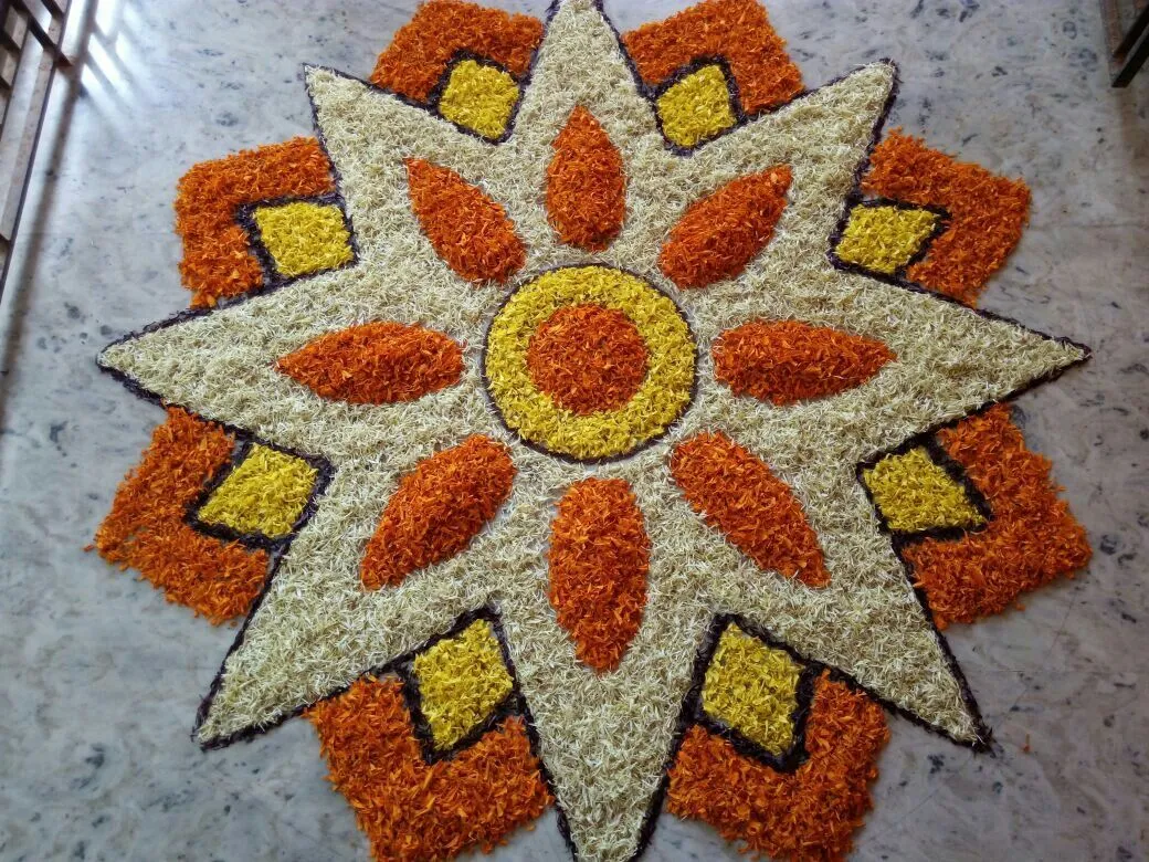 Starburst floral pookolam with orange and yellow petals HD