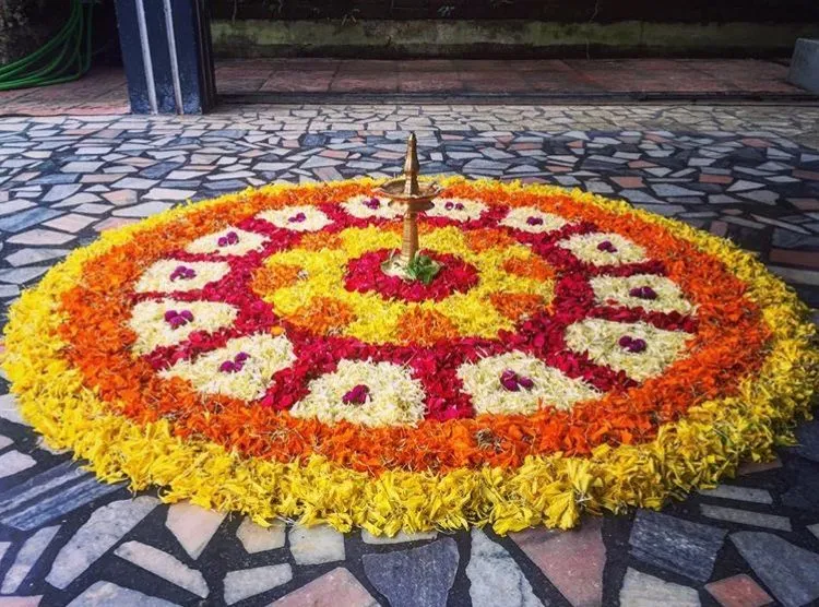 Stunning Athapookolam with a Brass lamp centerpiece image
