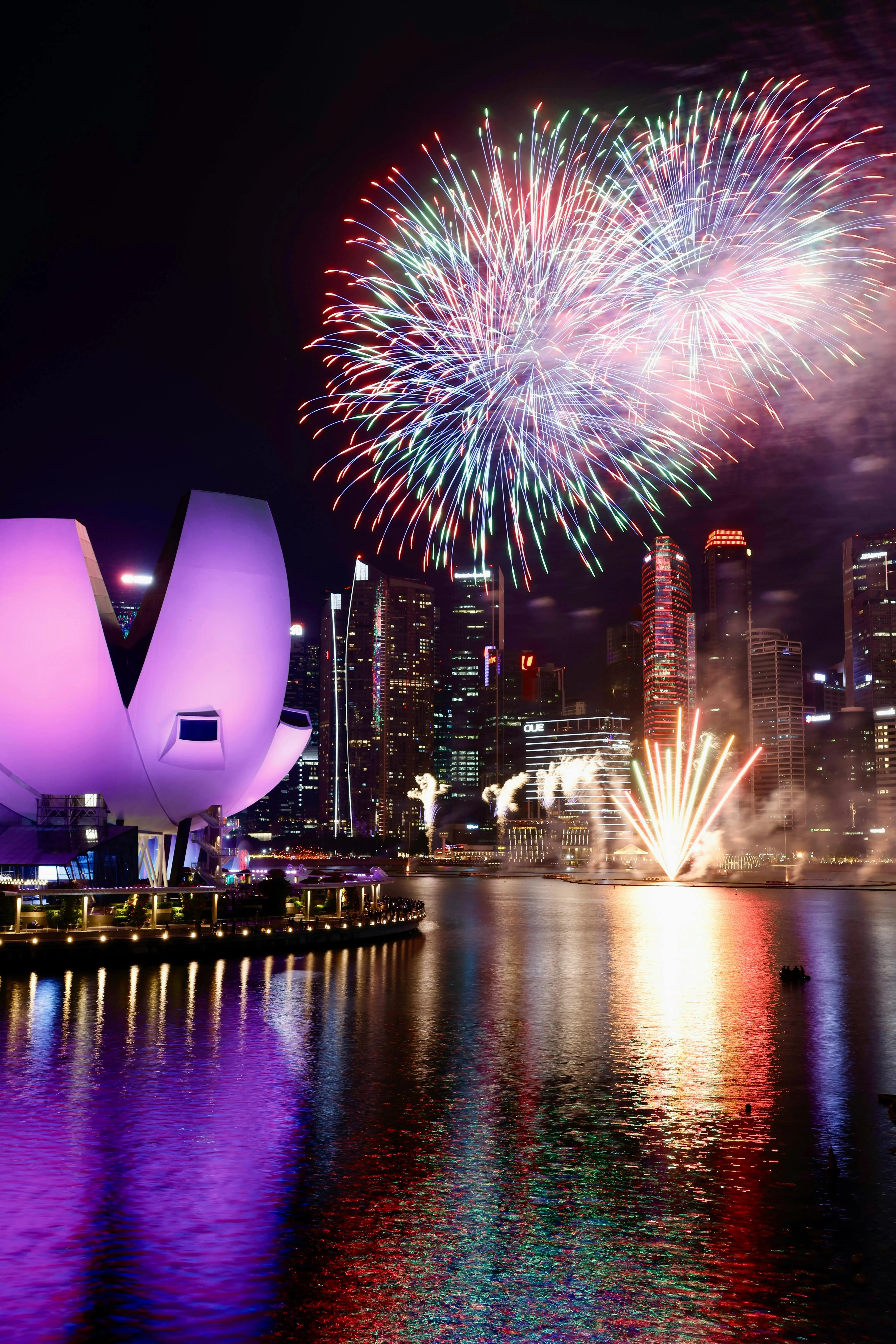 Stunning Fireworks over a Modern Waterfront Building
