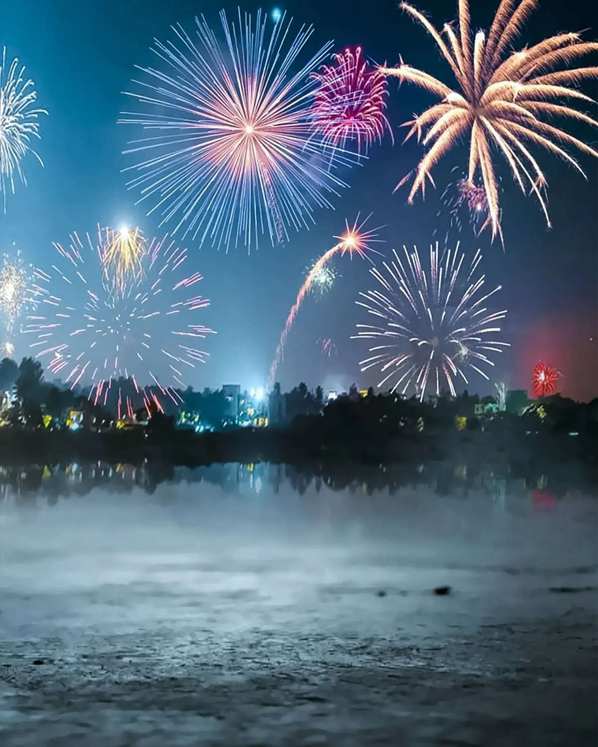 Stunning fireworks with reflections over the water at night