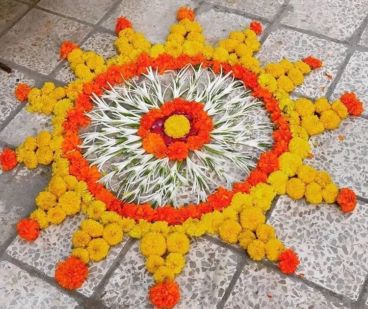 Sun design pookolam with marigolds and petals Wallpaper
