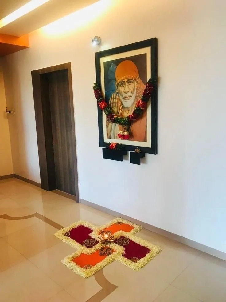 Swastik kolam with Flower Petals under Sai Baba Portrait