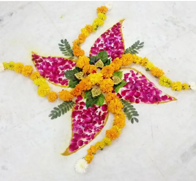 Swastik symbol in marigold flowers with rose petals pookolam