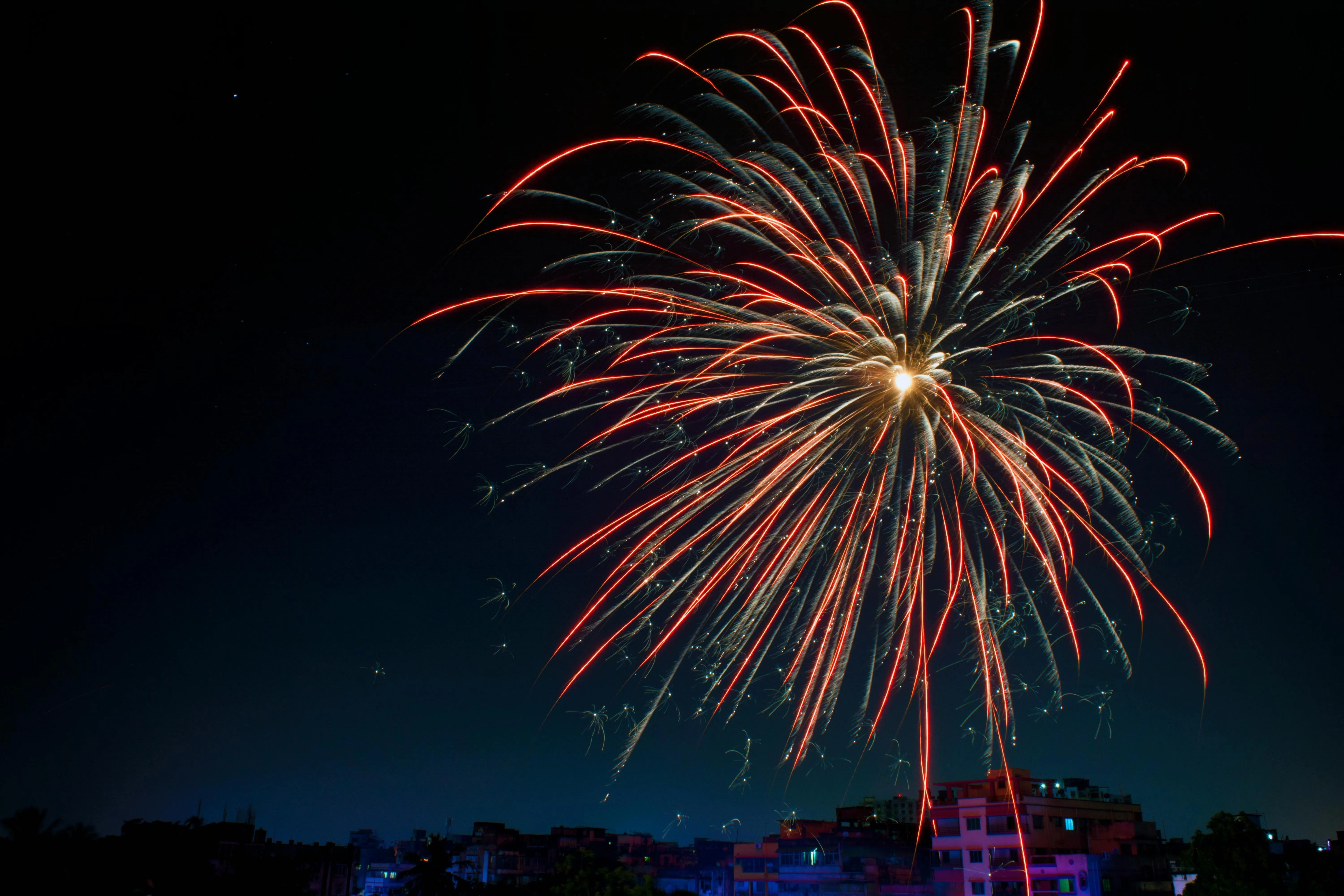Tall Firework Bursting with Bright Red and Yellow Colors