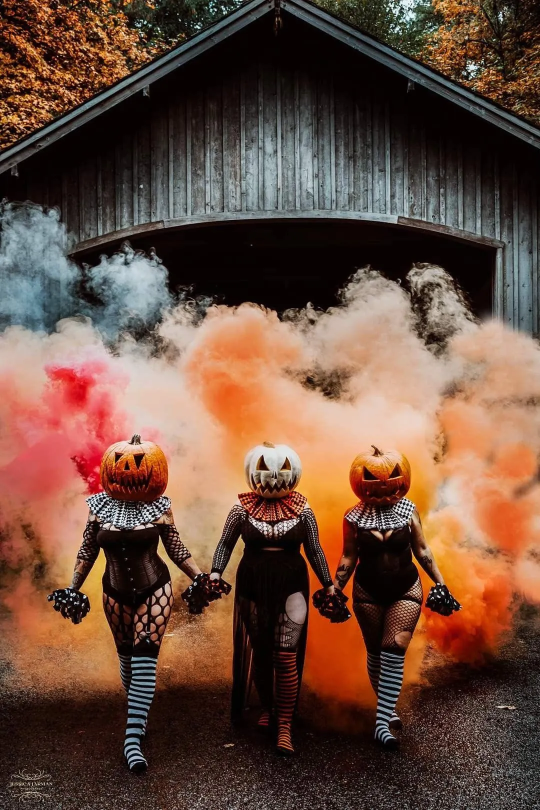 Three Women in Halloween Costumes with Orange Smoke Outdoors