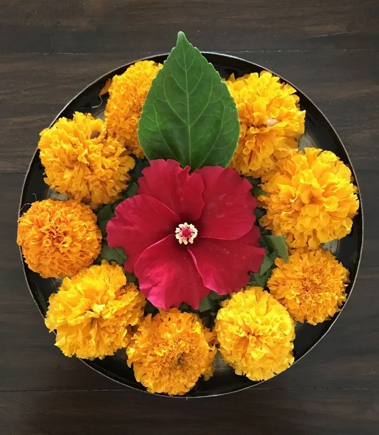 Traditional bowl with Marigold flowers and hibiscus image