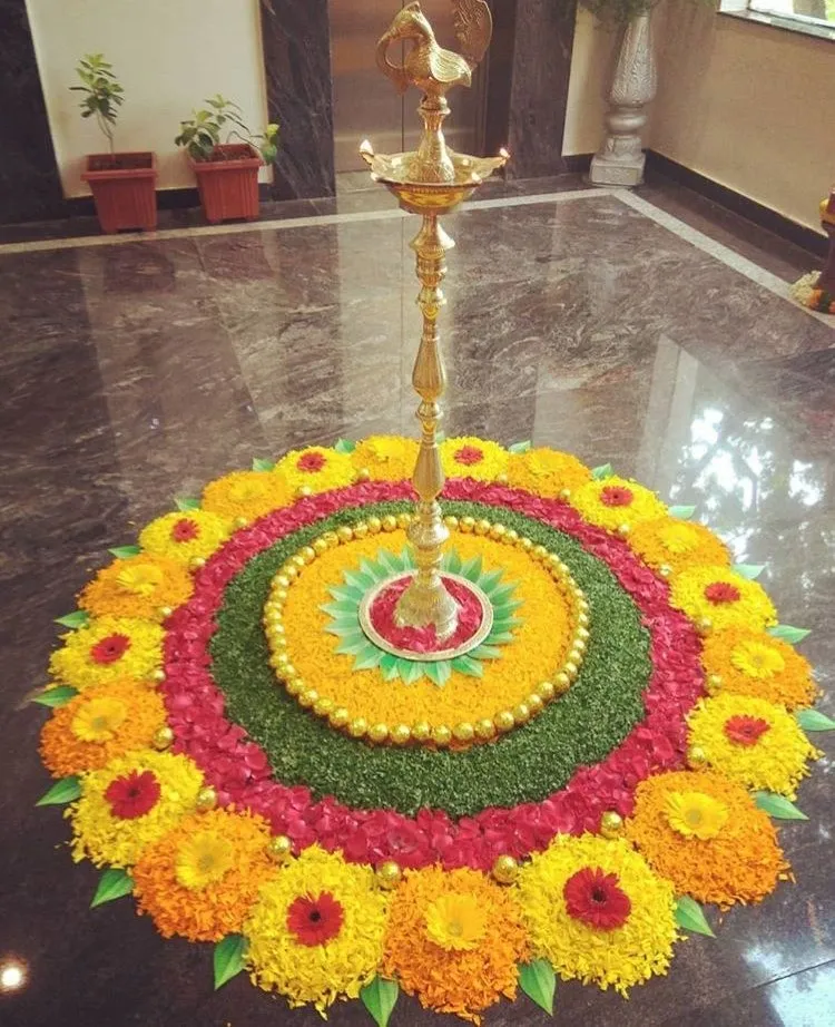 Traditional Circular pookolam design with a brass lamp HD