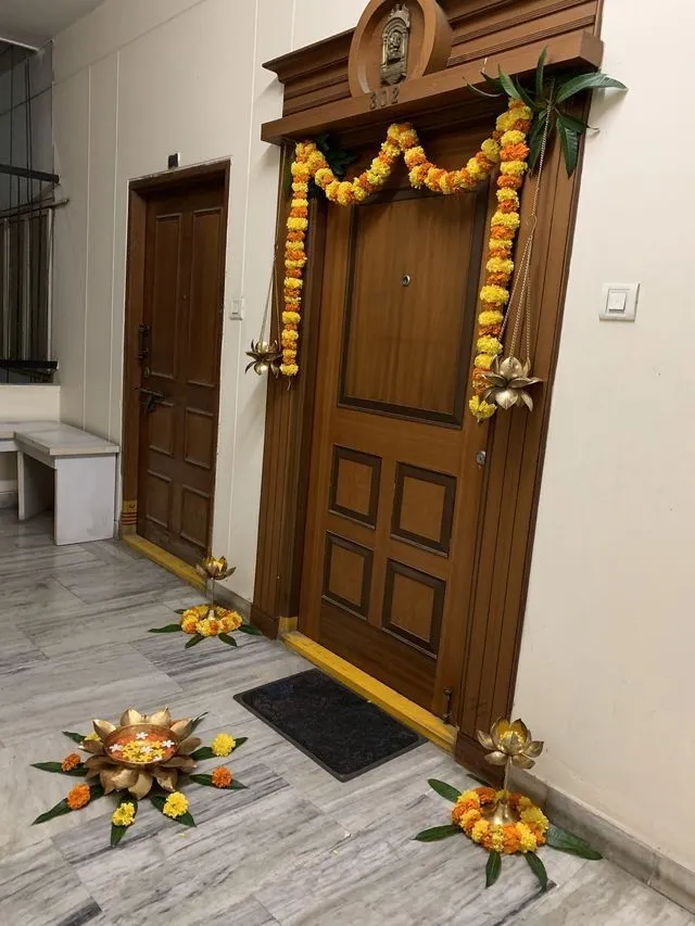 Traditional door decoration with Marigold garland and diyas