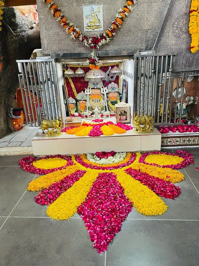 Traditional Half floral Onam Pookalam at temple entrance