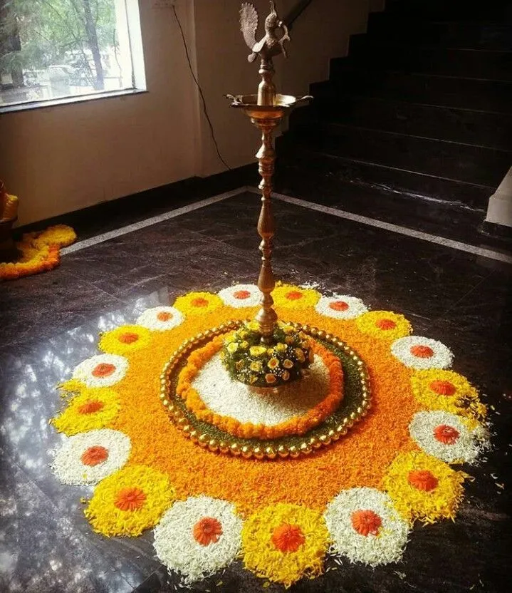 Traditional Onam Pookalam with nilavilakku Lamp wallpaper