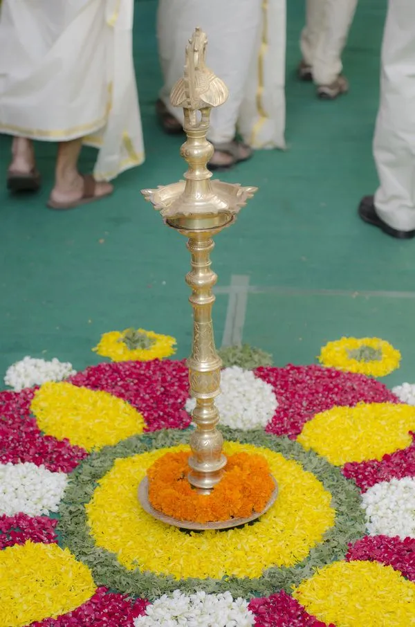Traditional Onam pookolam design with red and yellow petals
