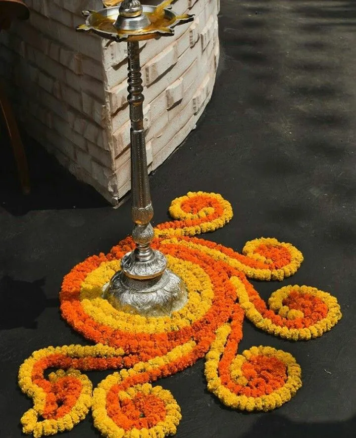 Traditional spiral pookolam with marigold flowers wallpaper