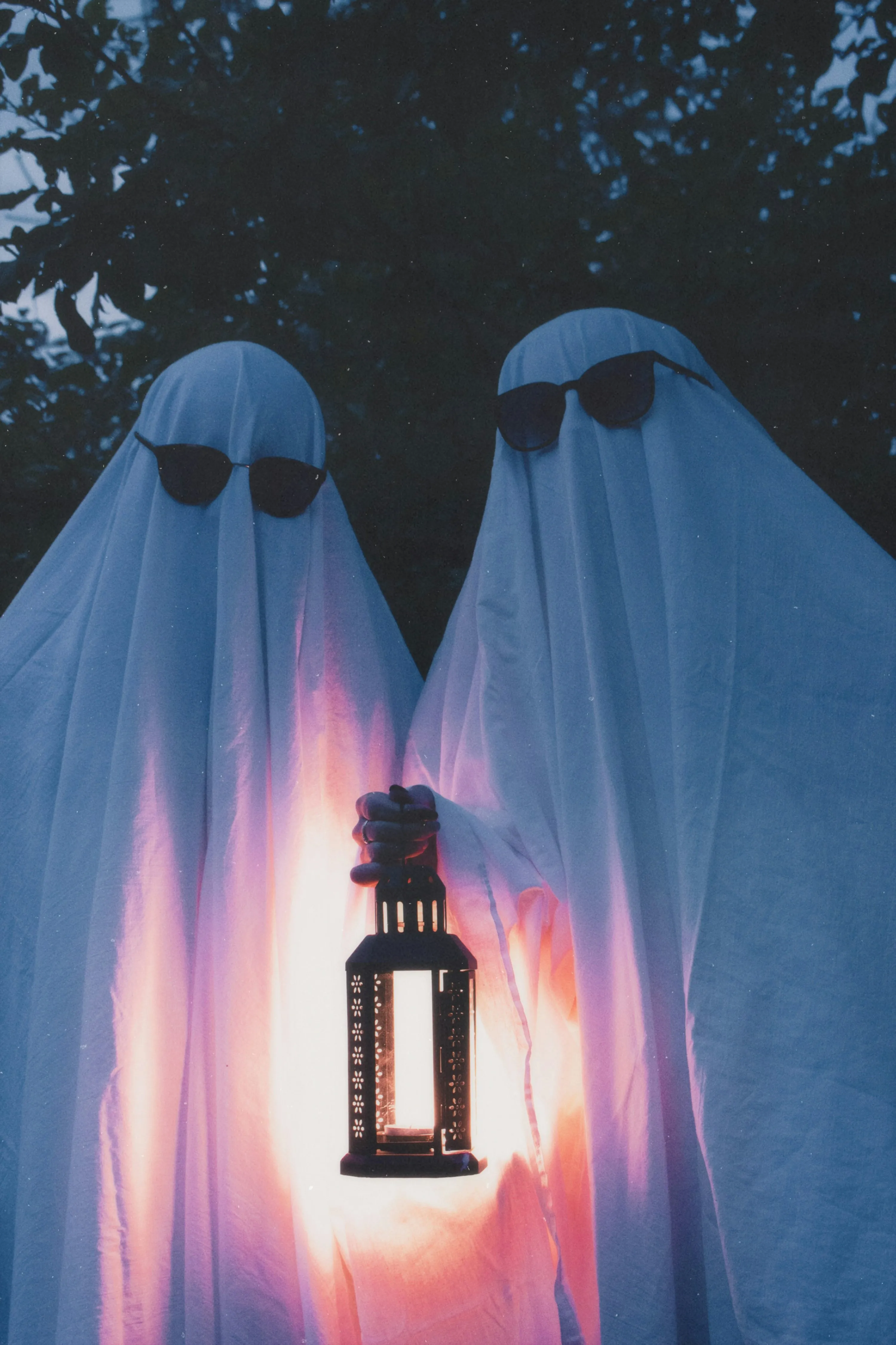Twin Ghosts Holding Lanterns in Spooky Scene Wallpaper