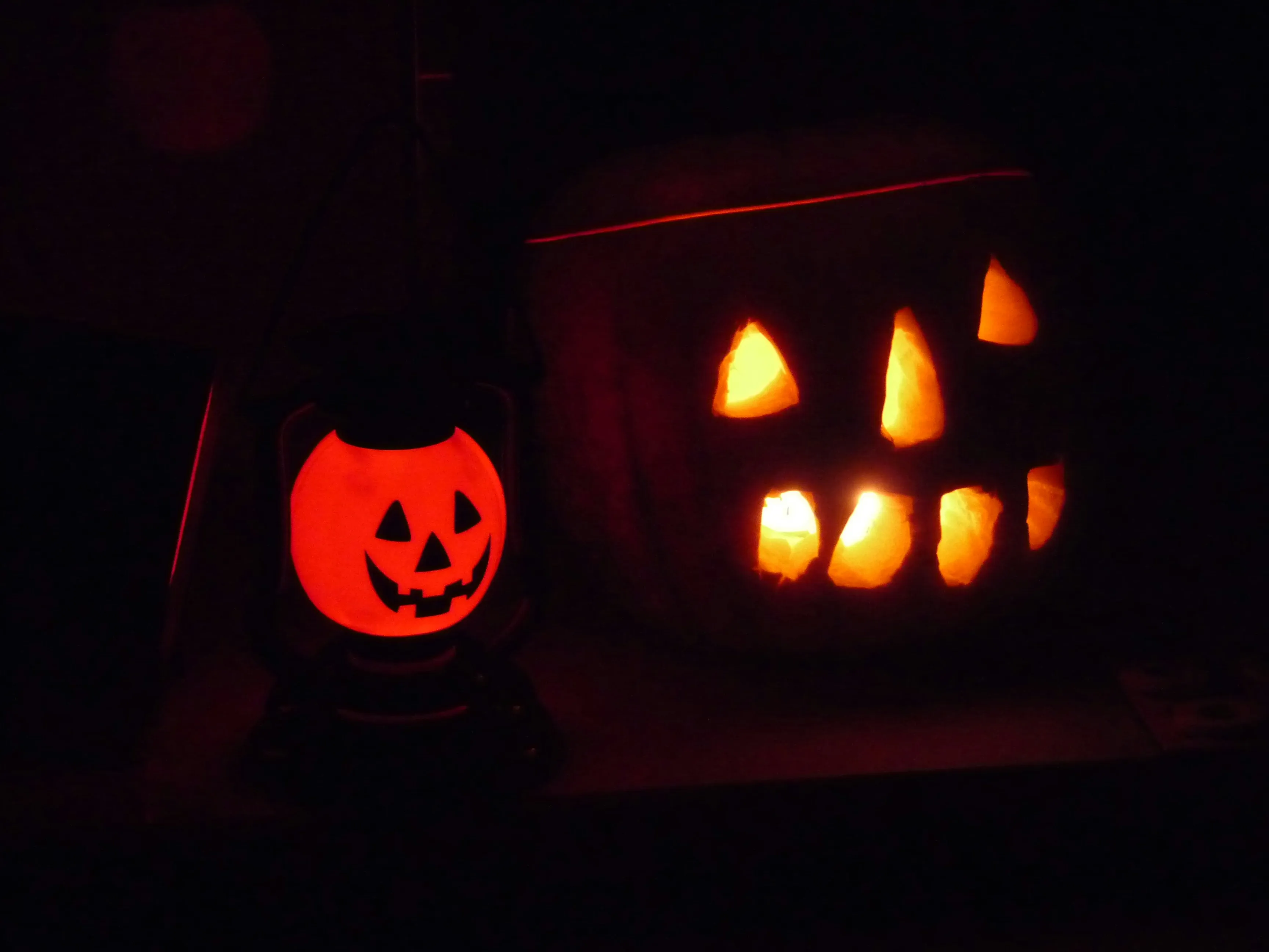 Two Carved Pumpkins Glowing in The Dark Halloween Night
