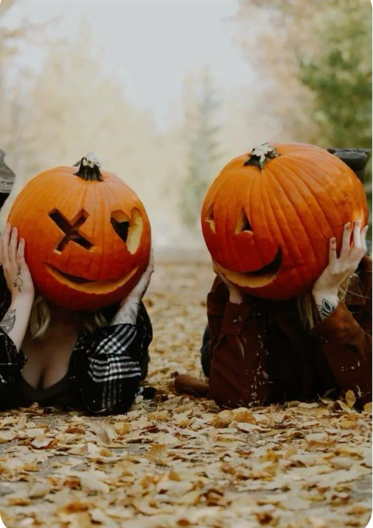 Two Couples in Pumpkins with Fun Faces in Autumn Setting