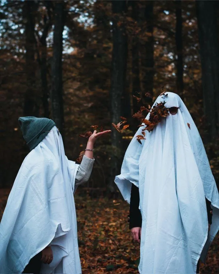 Two Ghost Costumes Walking in Forest at Halloween Night