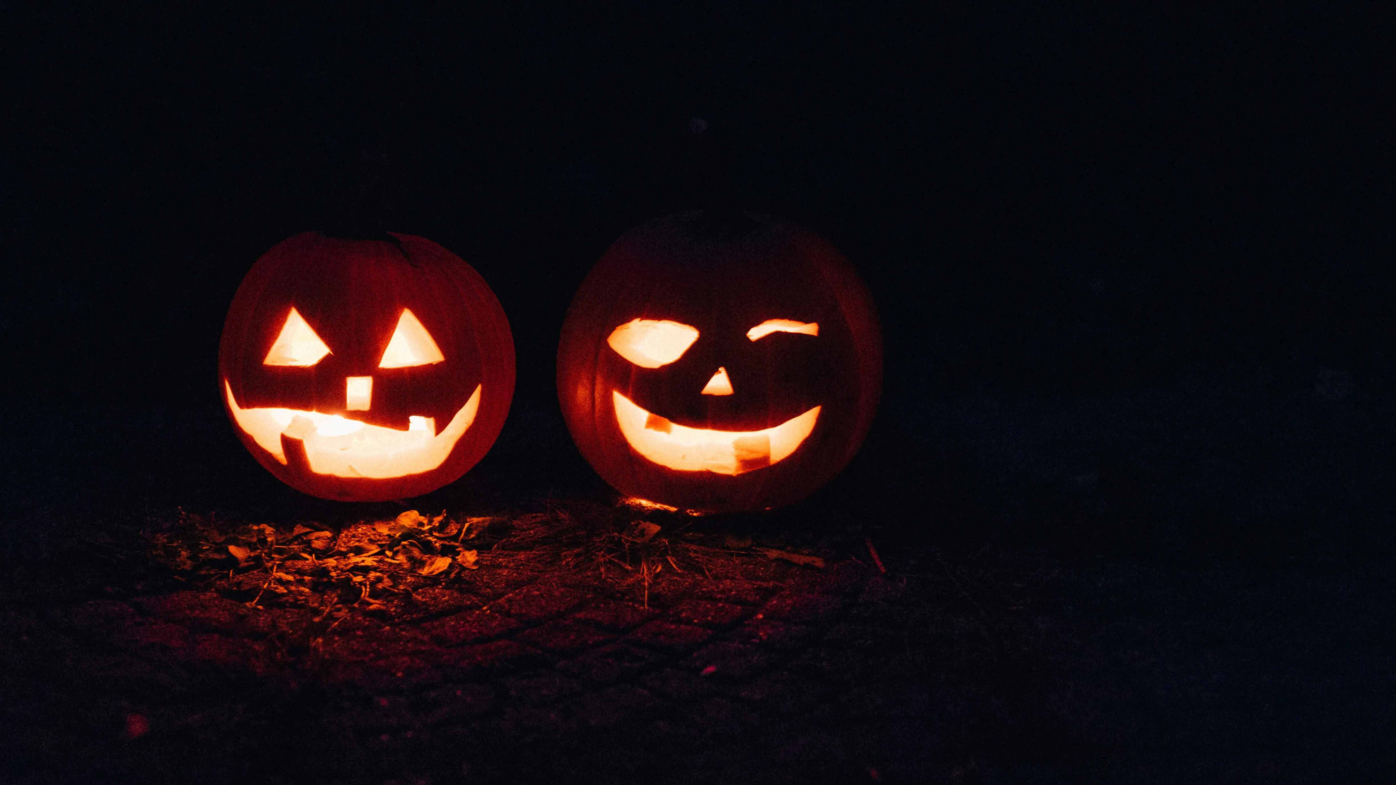 Two Glowing Pumpkins in The Darkness Of Night Wallpaper