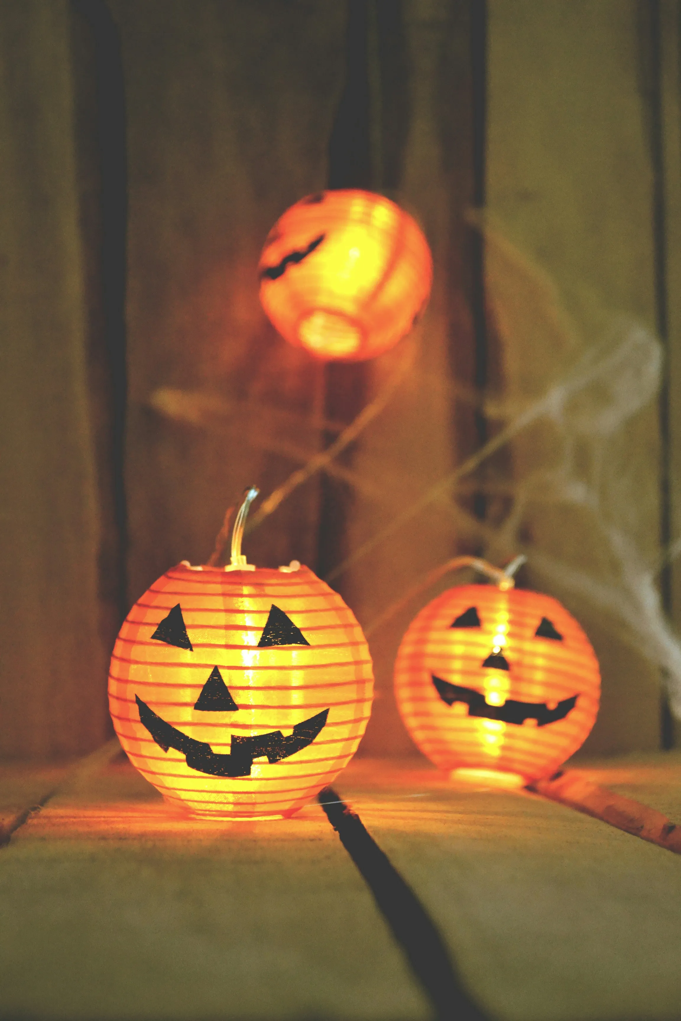 Two Jack O Lantern Paper Lanterns Glowing Softly Wallpaper