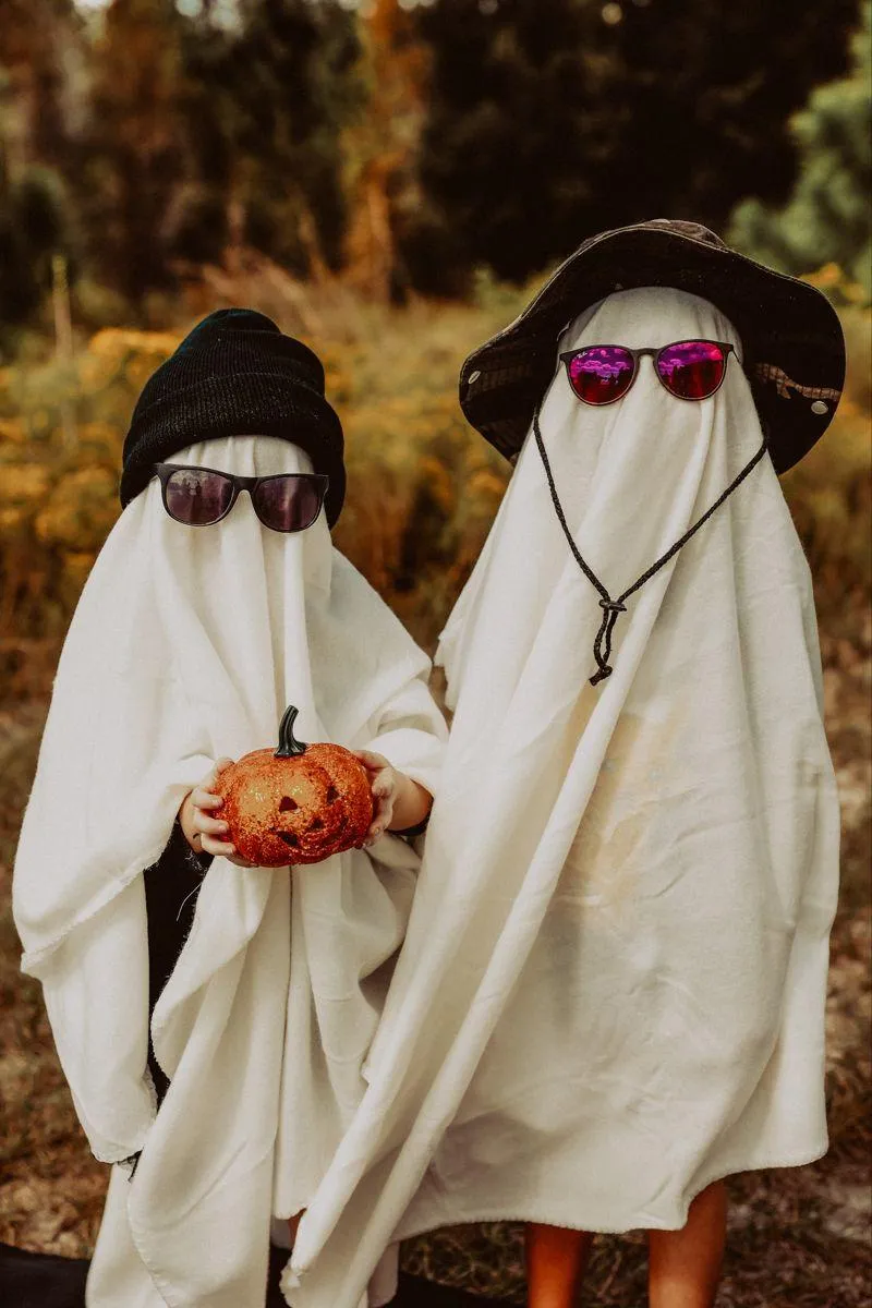 Two People Dressed as Ghosts with Pumpkin HD Wallpaper