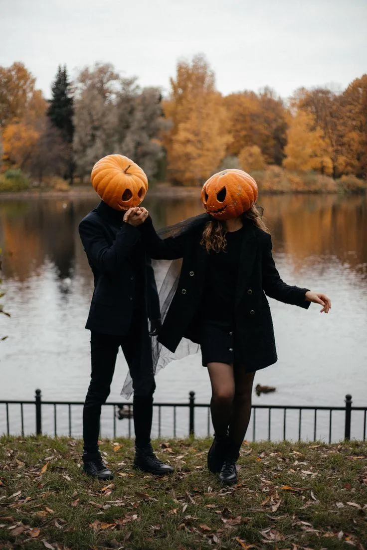 Two People in Pumpkin Heads Posing near the Lake image