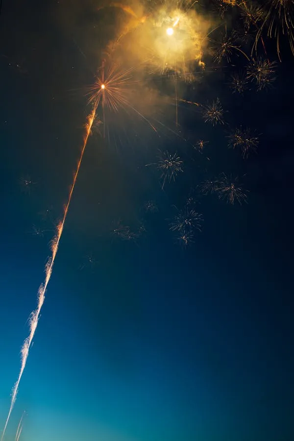 Vertical Firework Trailing Sparkles During Launch image