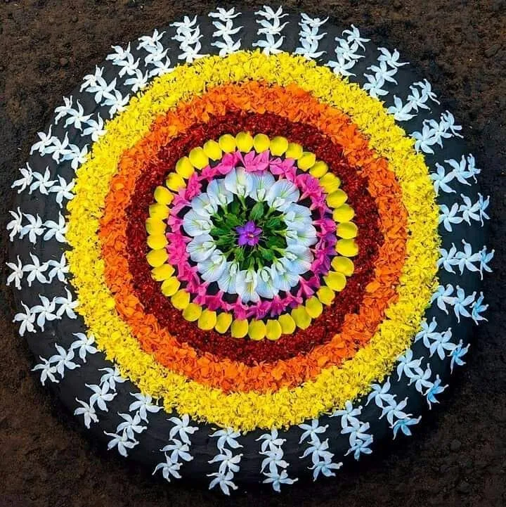 Vibrant circular layer rangoli with jasmine borders image