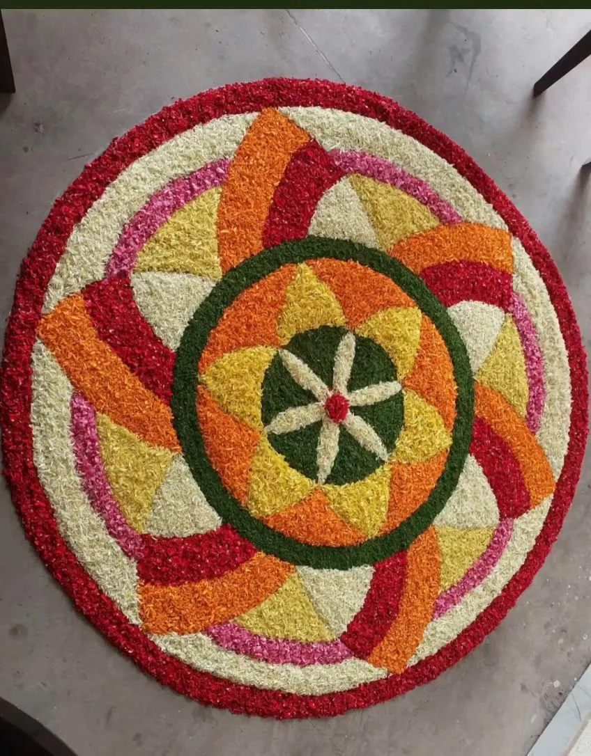 Vibrant circular Onam pookalam with geometric petals