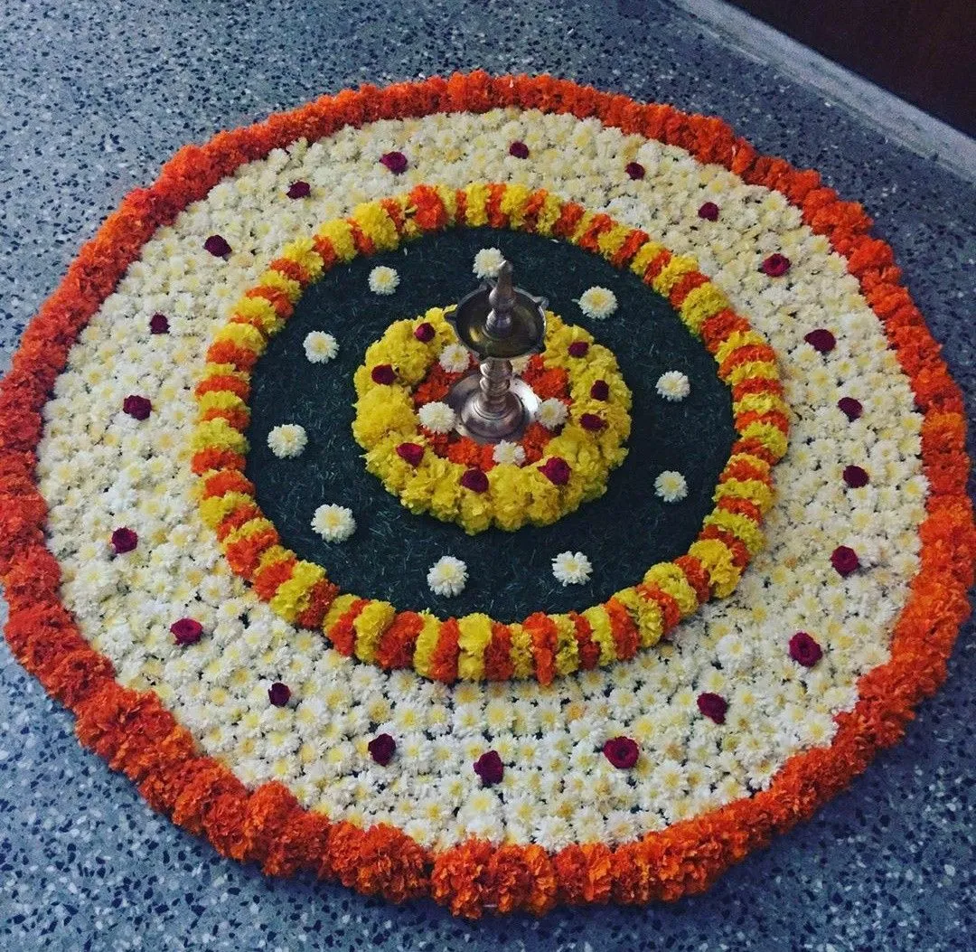 Vibrant colourful Athapookolam with marigolds and daisies