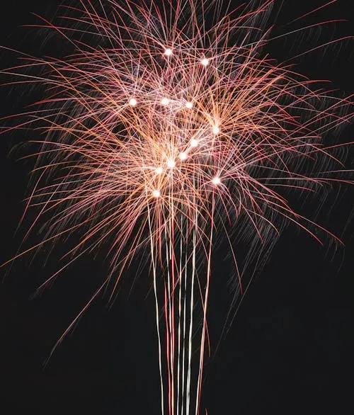 Vibrant Firework Burst with Multicolored Trails Wallpaper