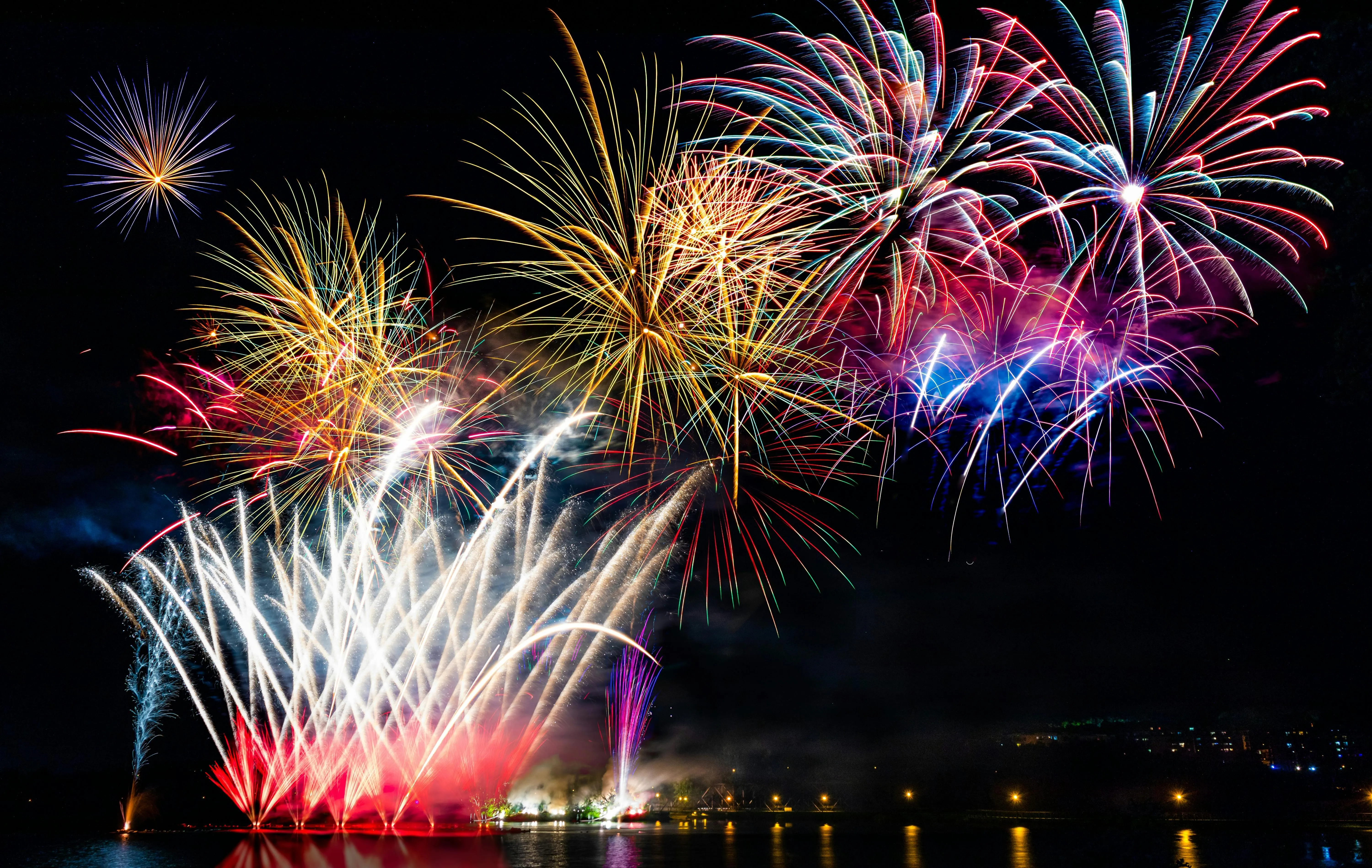 Vibrant Fireworks Bursting High in the Evening Sky