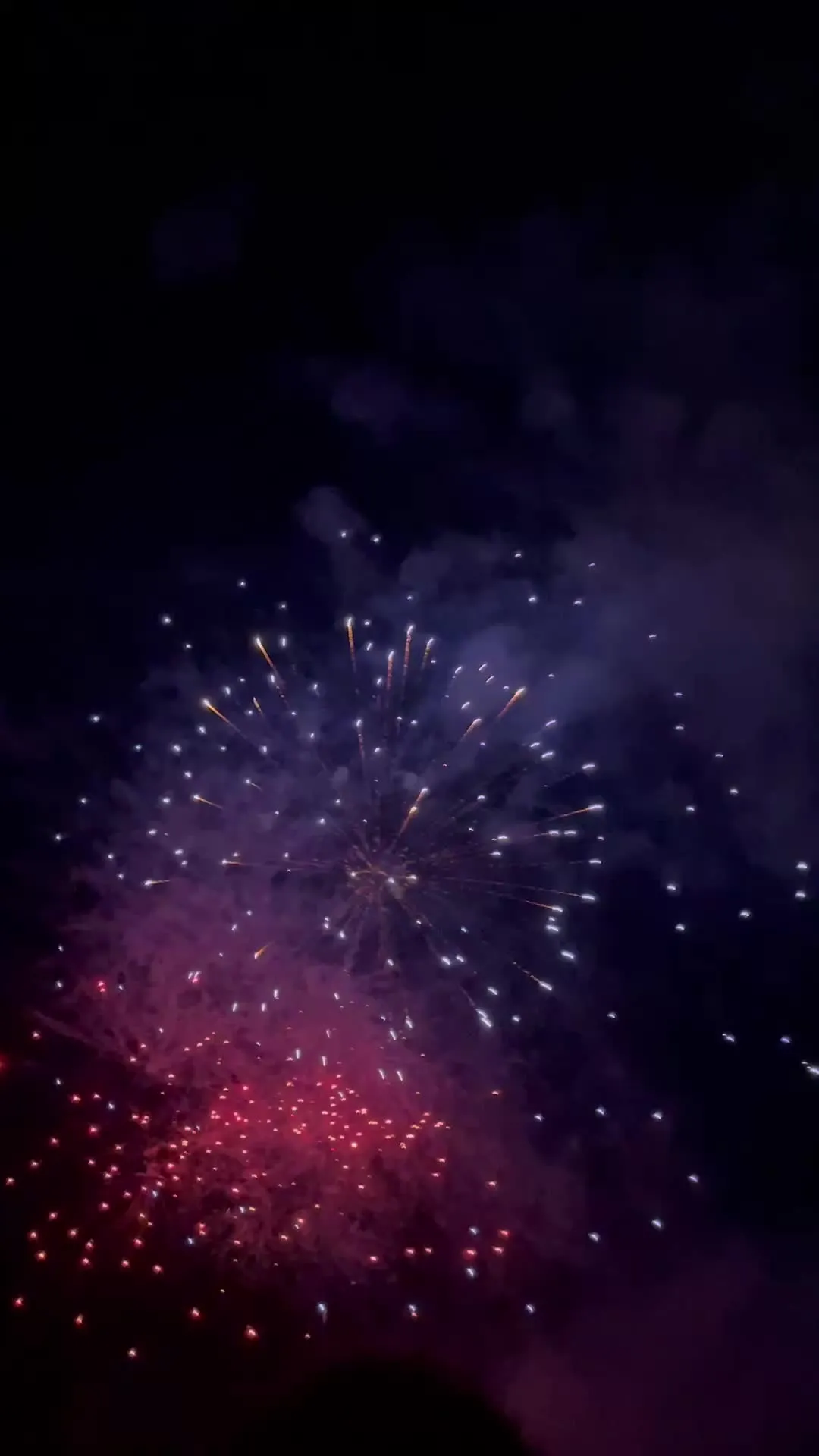 Vibrant fireworks show with distant glowing patterns image